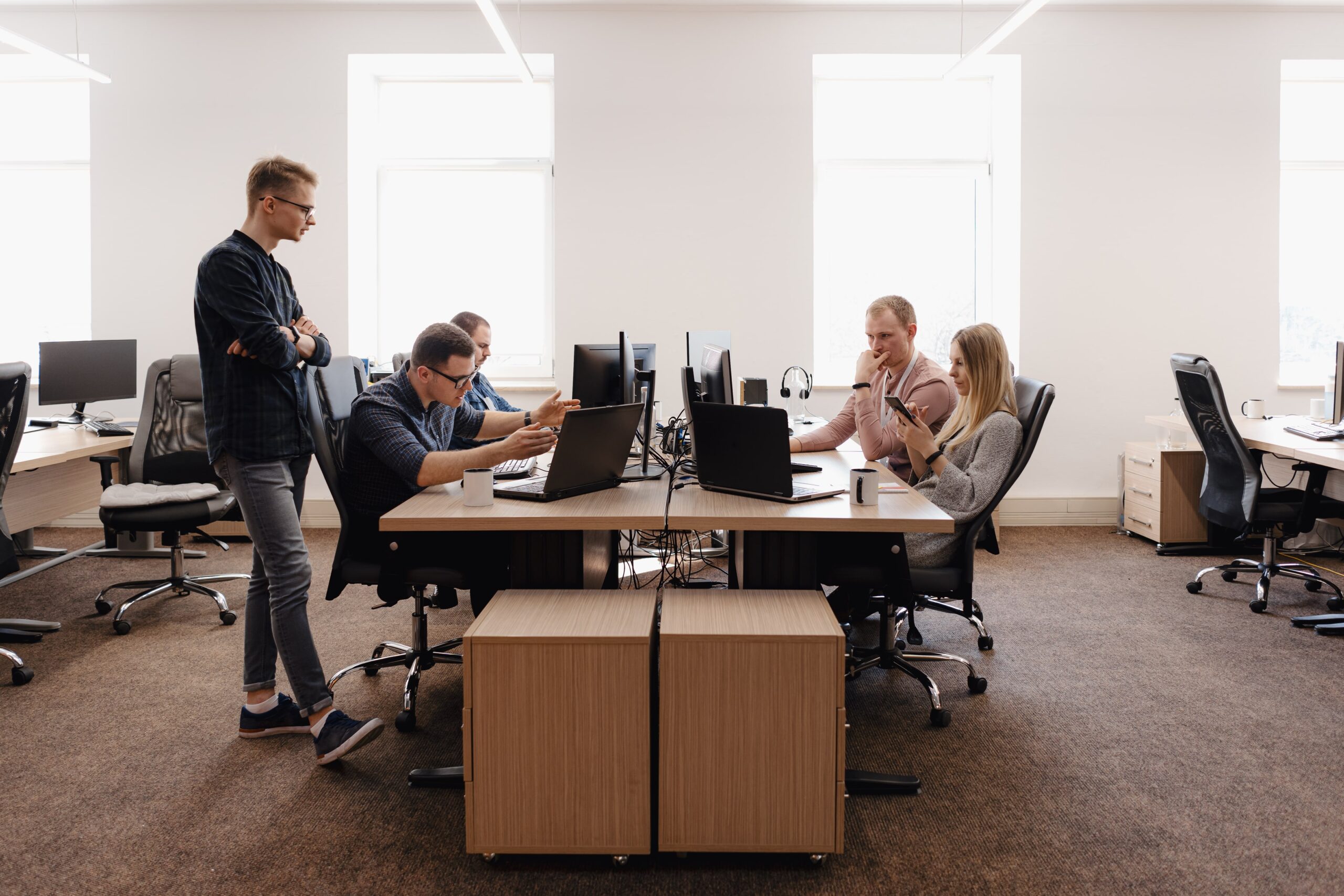 Team collaborating in modern office, enhancing user experience for BrowseLoan’s digital transformation.