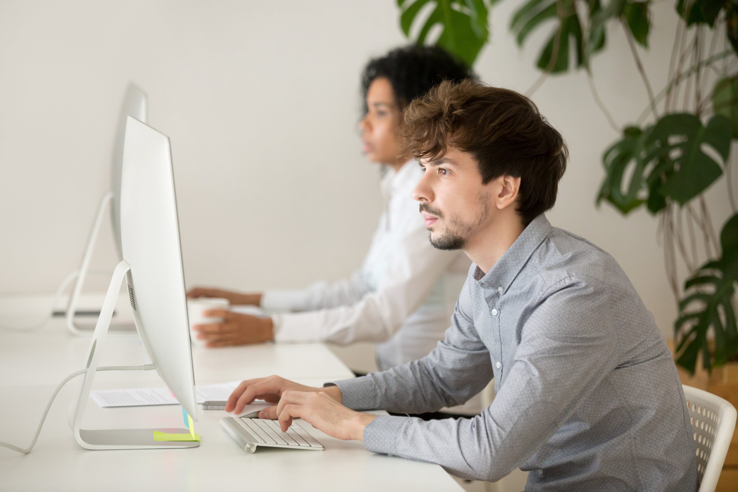 Two individuals collaborating at computers in a modern workspace, reflecting Enterprised's software development focus.